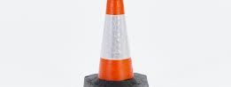 Single orange and white reflective traffic cone on a heavy black base