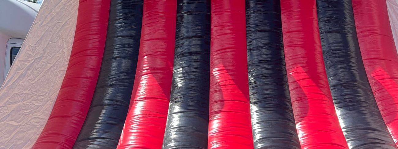 Four-lane red and black inflatable basketball game with numbered hoops