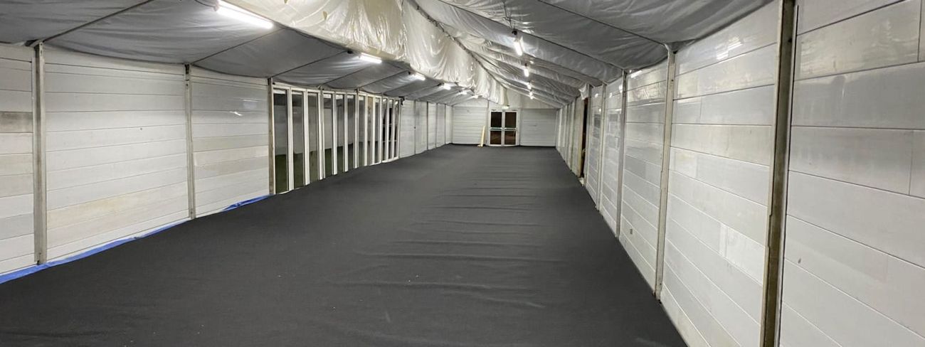 White marquee interior lit overhead by a row of 5ft LED strip lights