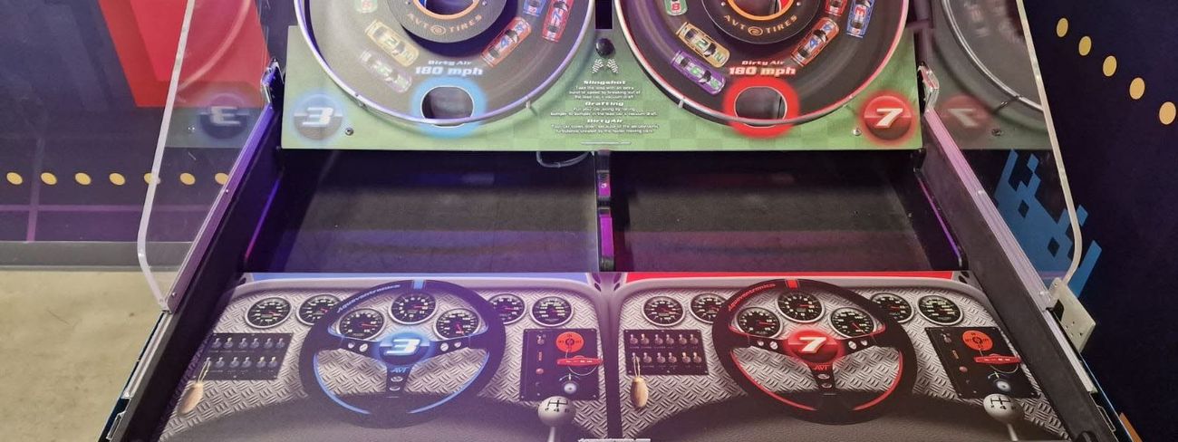 Two-player Speedway 500 bounce-a-ball game with red and blue racing-themed launch pads and steering wheels