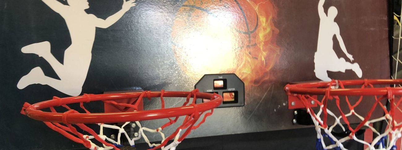 Twin red basketball hoops with Shootout Hoops graphic backboard