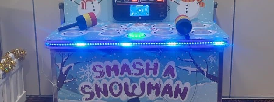 Whack a Snowman arcade cabinet with snowman backboard graphics, digital scoreboard and foam mallets