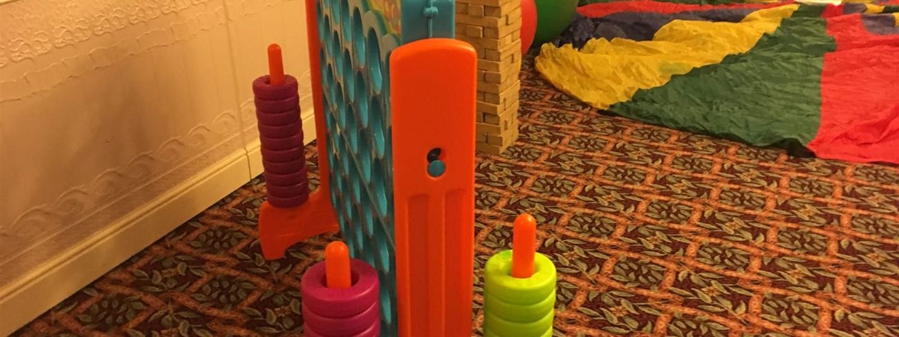 Giant Connect 4 beside Giant Jenga in a relaxed party games area