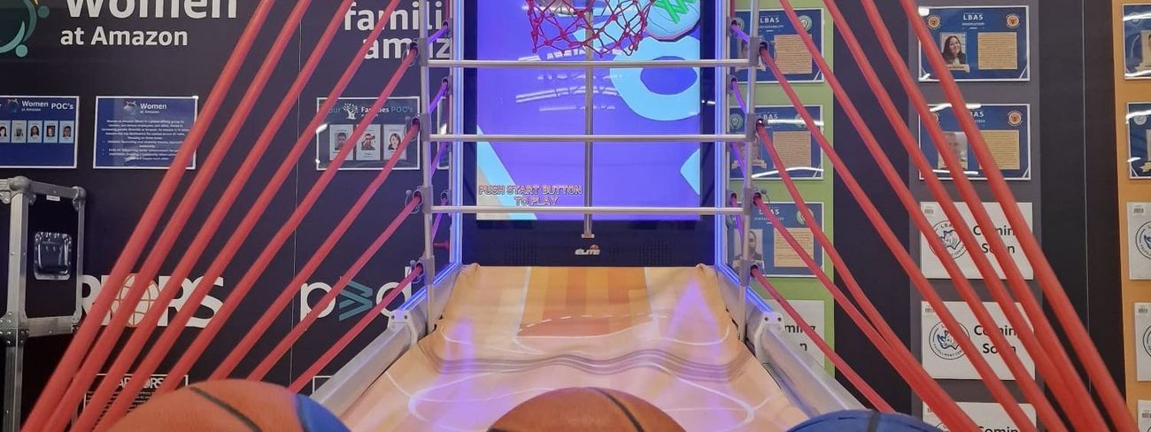 Interactive arcade basketball game in use at a busy Amazon corporate event