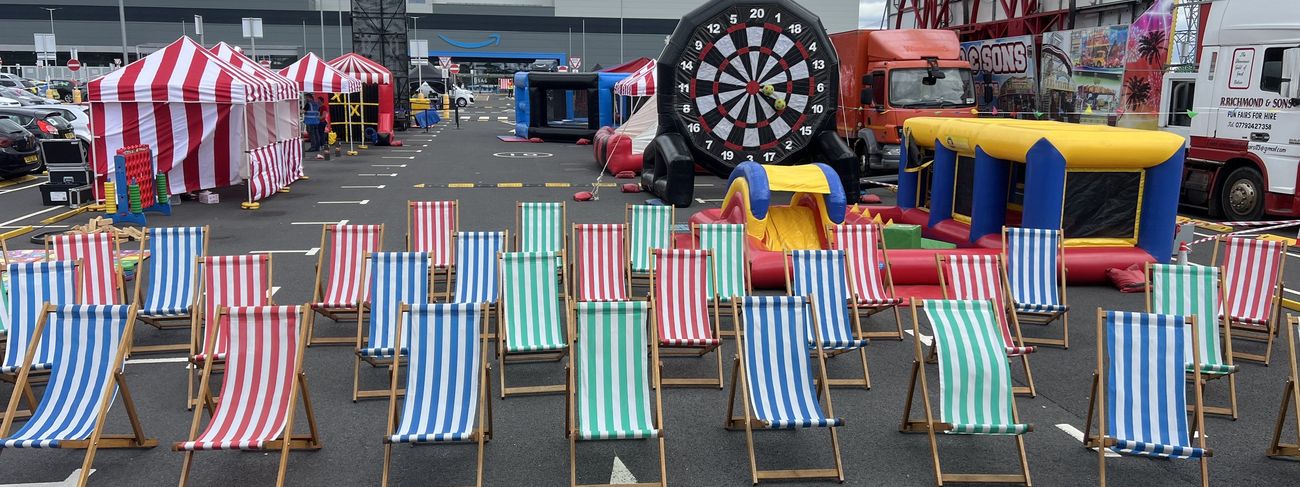 Wide overview of an Amazon-branded event packed with games, deck chairs and inflatables