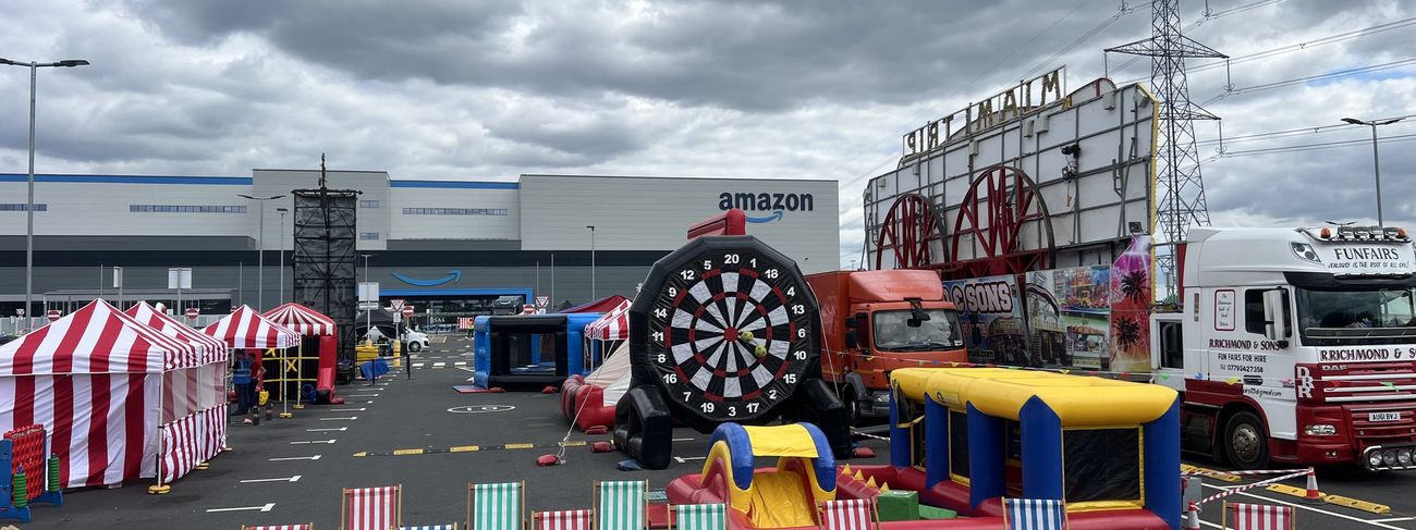Amazon event overview with deck chairs and a giant inflatable dartboard