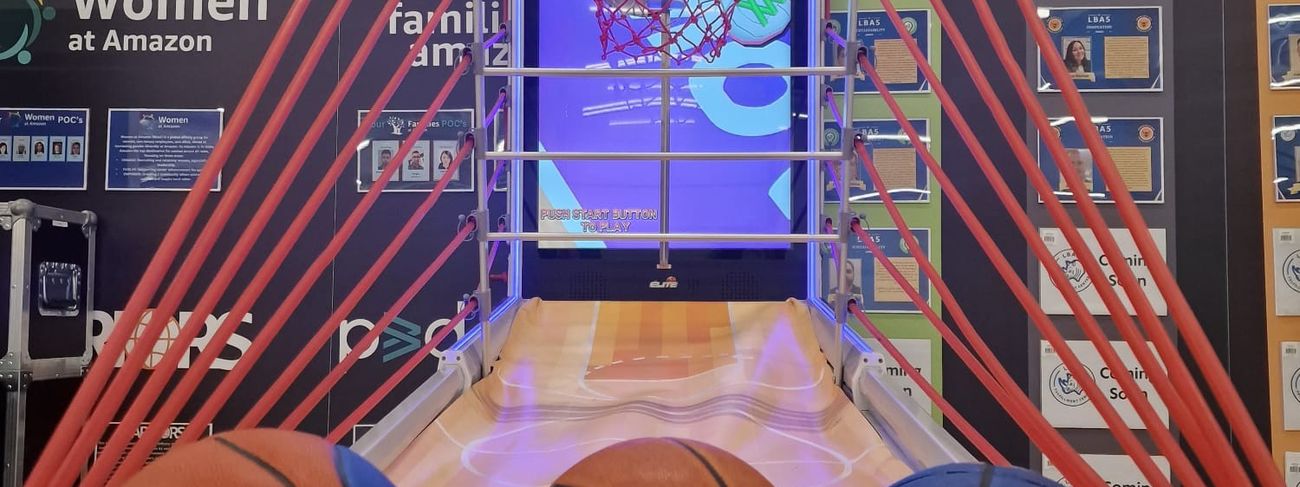 Interactive arcade basketball game in use at a busy Amazon corporate event