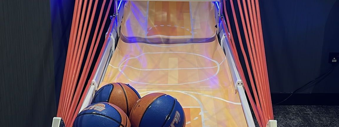 Interactive arcade basketball game set up at an indoor event