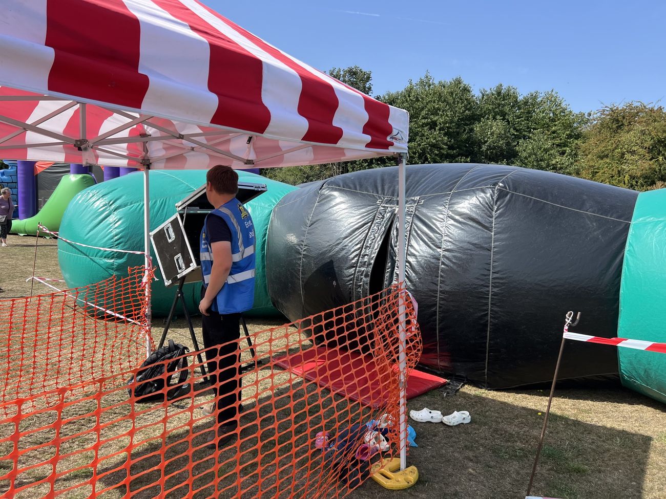 Ballnado grabber prize game with a branded header set up at an event