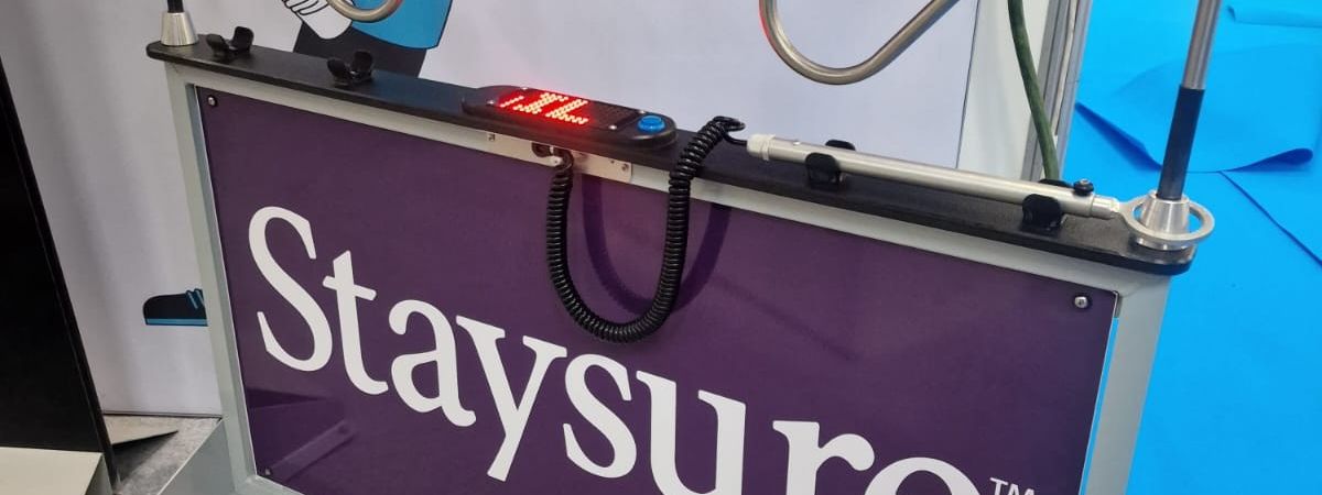 Giant buzz wire game with full Staysure branding on the side panels