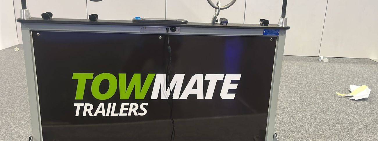 Giant buzz wire game wrapped in Towmate branding at a trade show