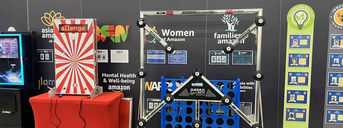 Giant Connect 4 game on a branded Amazon stand with carnival sign