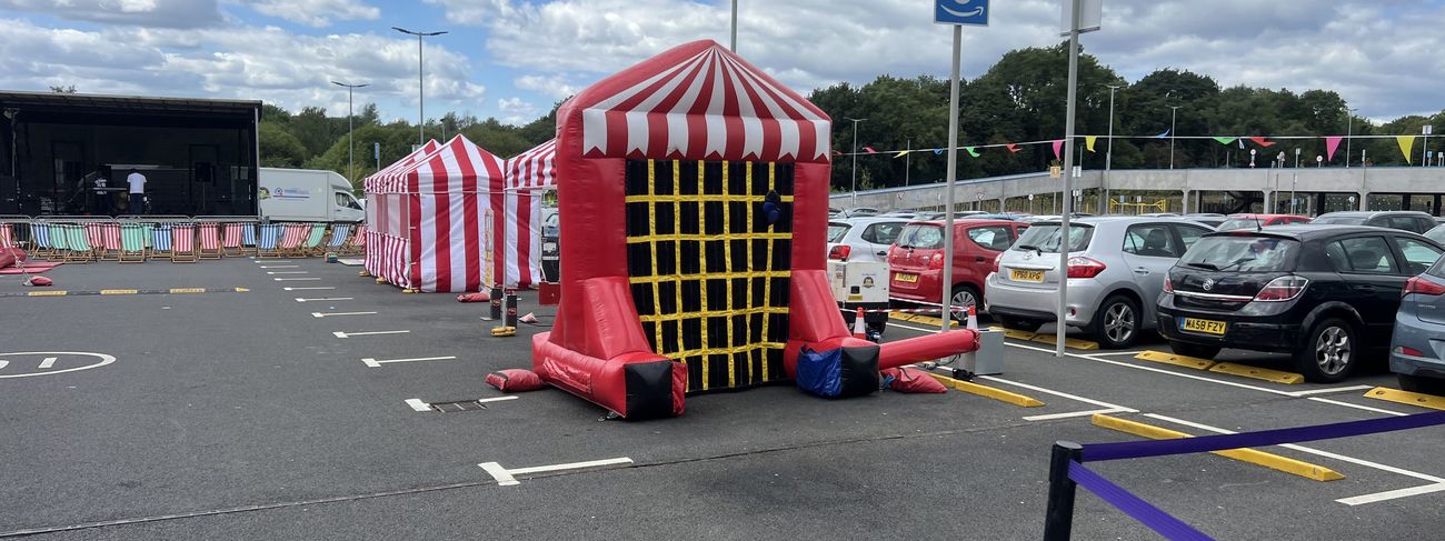 Red and white striped traditional high striker test-your-strength game at a corporate event