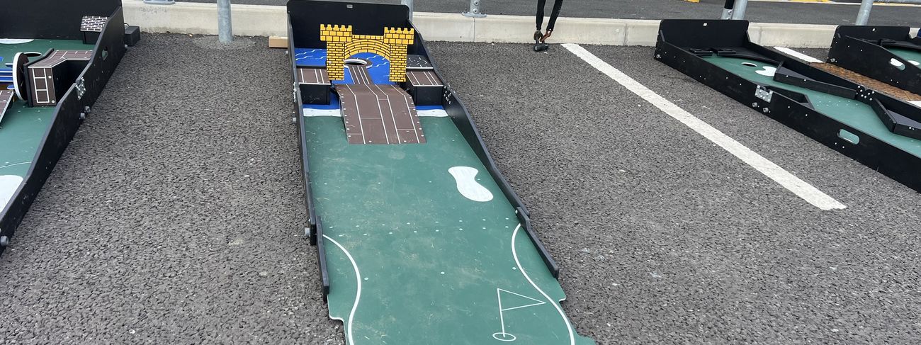 Inflatable 9-hole mini golf course set up across an event space