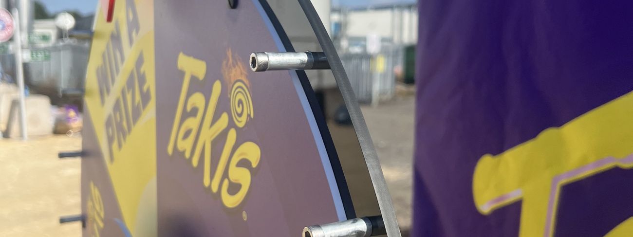 Prize wheel fully wrapped in Takis campaign artwork
