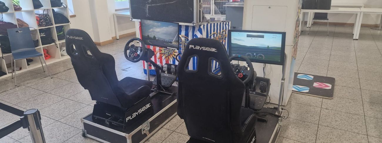 Racing car simulator with branded panels at a corporate event