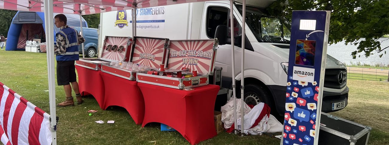 Branded social media photo booth surrounded by carnival stalls at an Amazon event