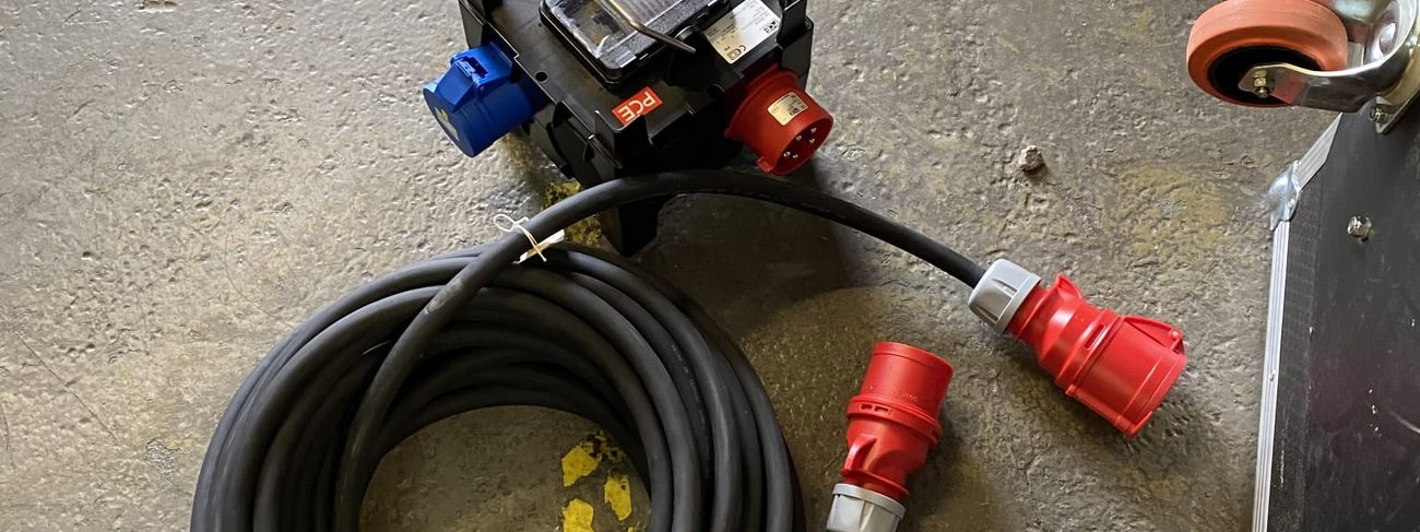 32 amp 415V IMST power distribution box on a workshop floor with a coiled red 3-phase tail
