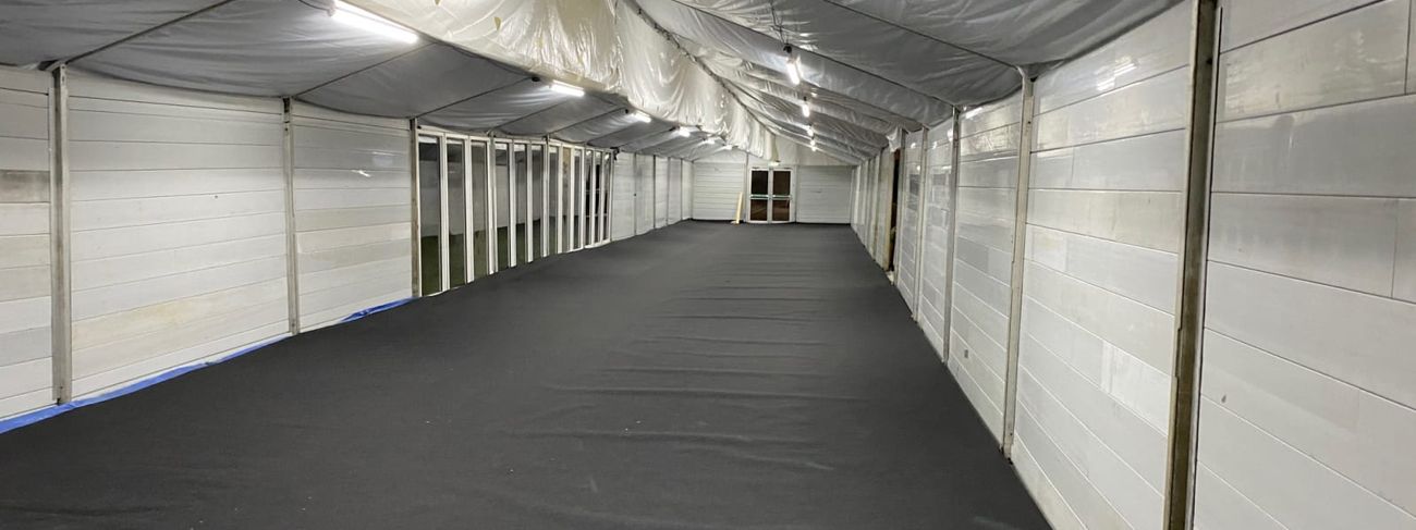 White marquee interior lit overhead by a row of 5ft LED strip lights