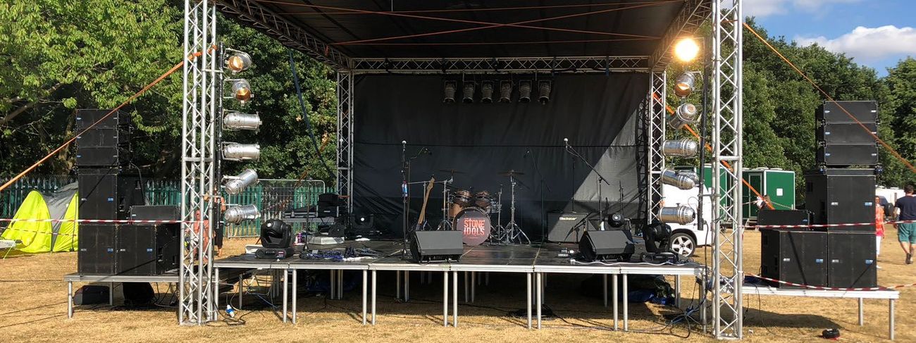 Festival stage with PA wings on parkland