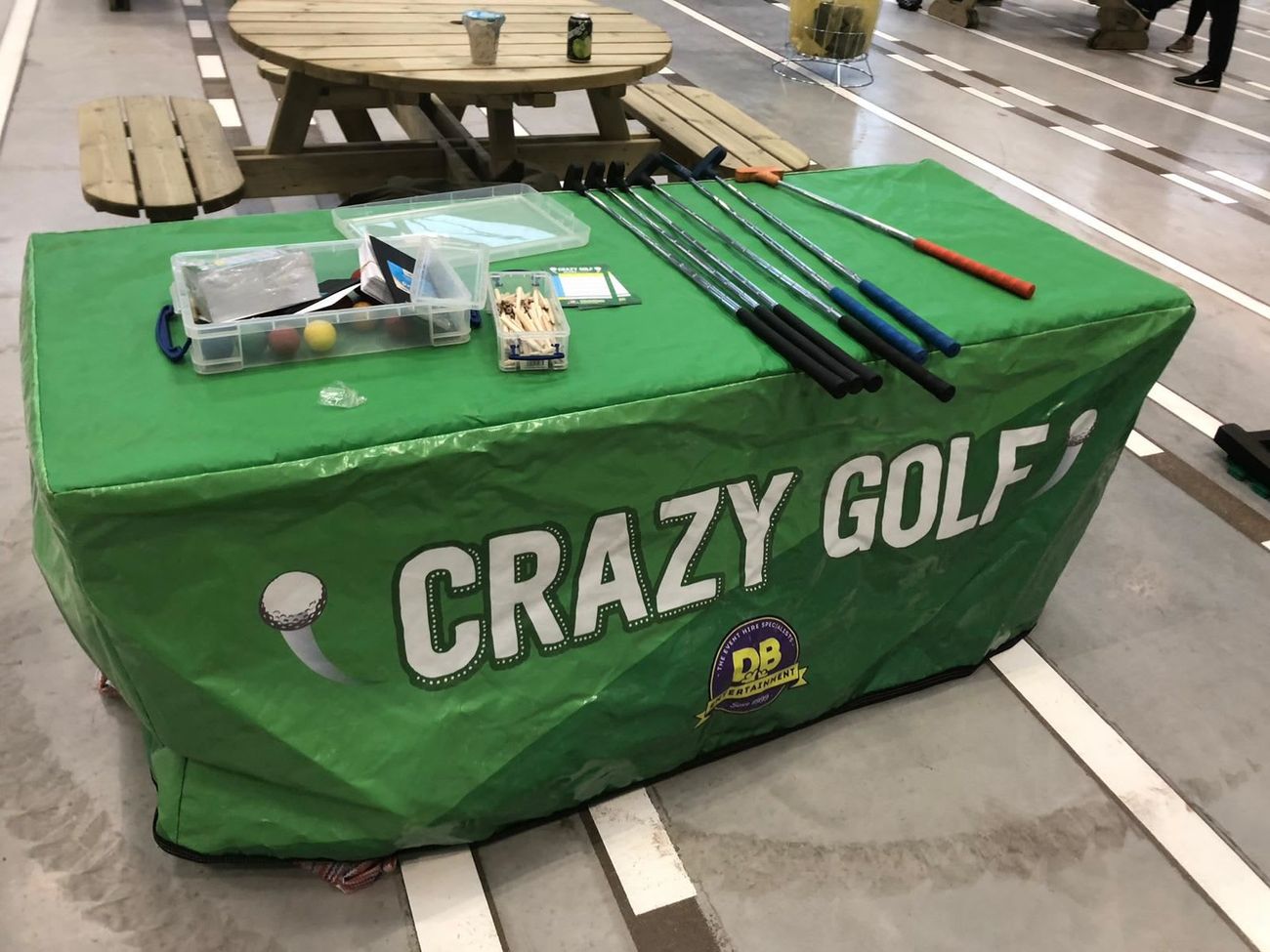 Putters, balls and tees laid out on the equipment table