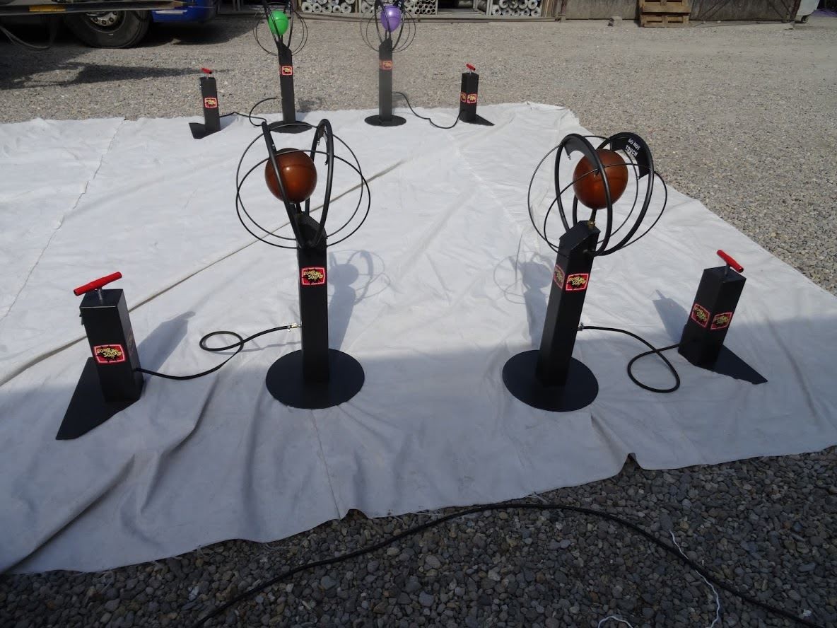 Balloon Bomb Squad stations on a white tarpaulin showing pumps, balloons in cages and disarm timers