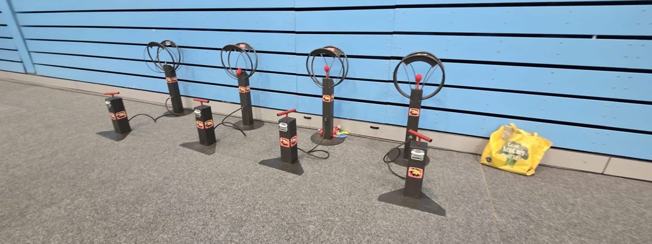 Balloon Bomb Squad five-station setup against a blue venue wall
