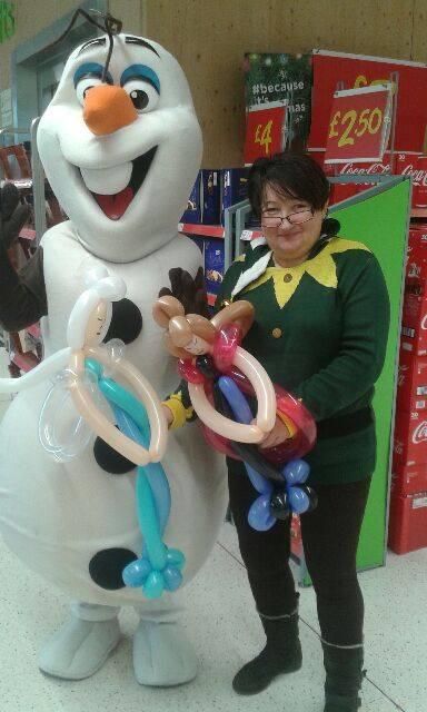 Elsa and Anna character figures made from multiple balloons at a store event