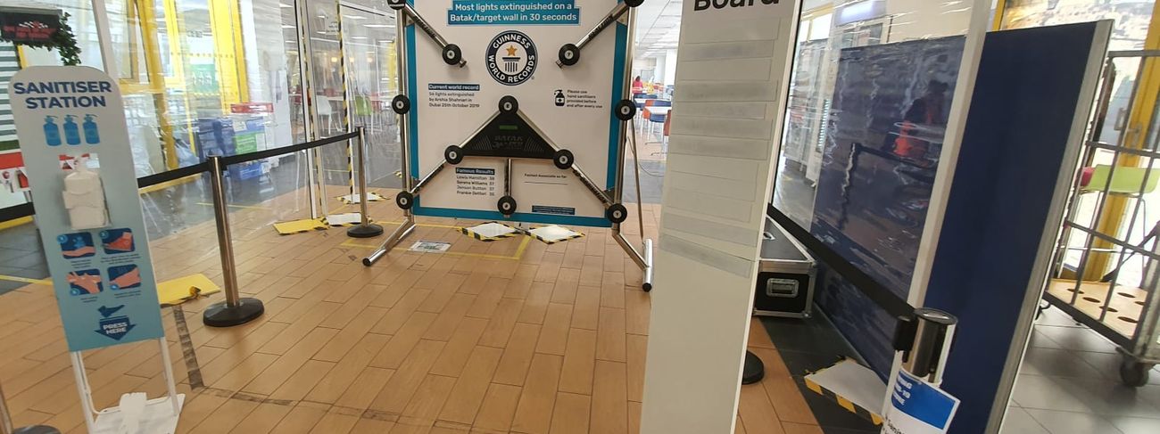 Batak Pro reaction wall set up in a shopping centre with magnetic leaderboard and rope barriers