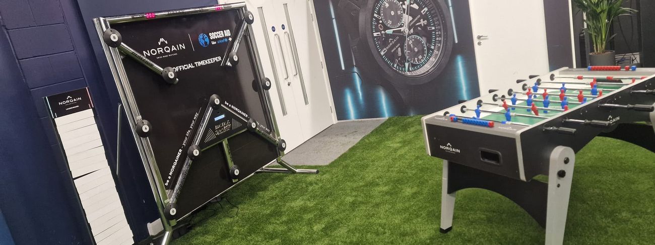 Branded Batak Pro reaction game, magnetic leaderboard and branded football table set up on artificial grass inside Wembley Stadium