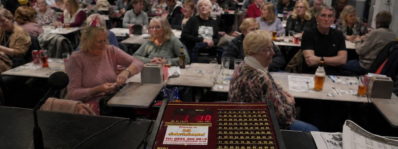 Bingomatic console in the foreground of a crowded bingo hall