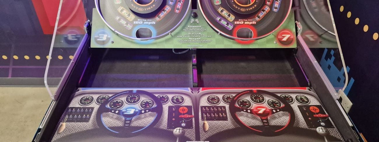 Two-player Speedway 500 bounce-a-ball game with red and blue racing-themed launch pads and steering wheels
