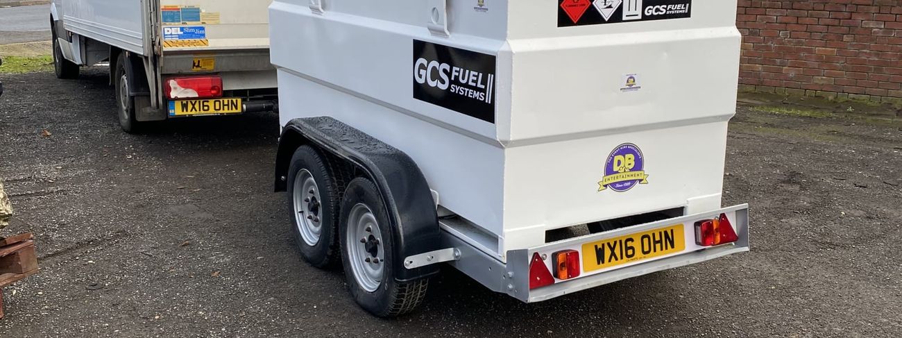 White twin-axle bunded diesel fuel trailer parked behind a delivery van