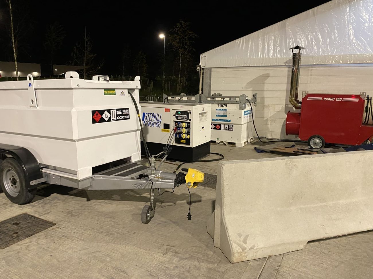 Bunded diesel fuel trailer set up at night beside a Stephill generator and a Jumbo heater