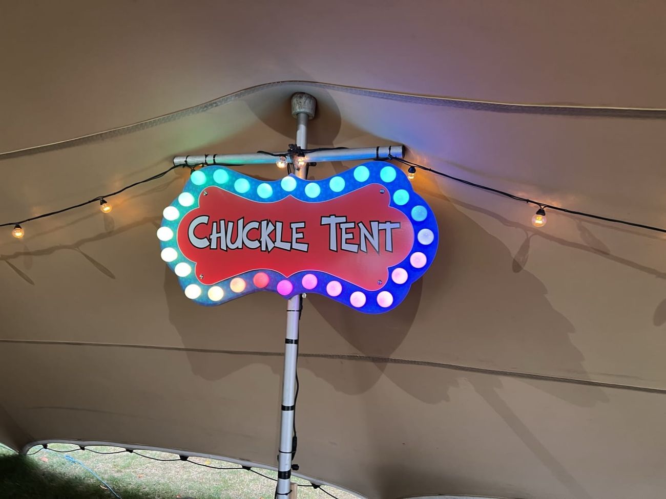 Chuckle Tent sign hanging inside marquee