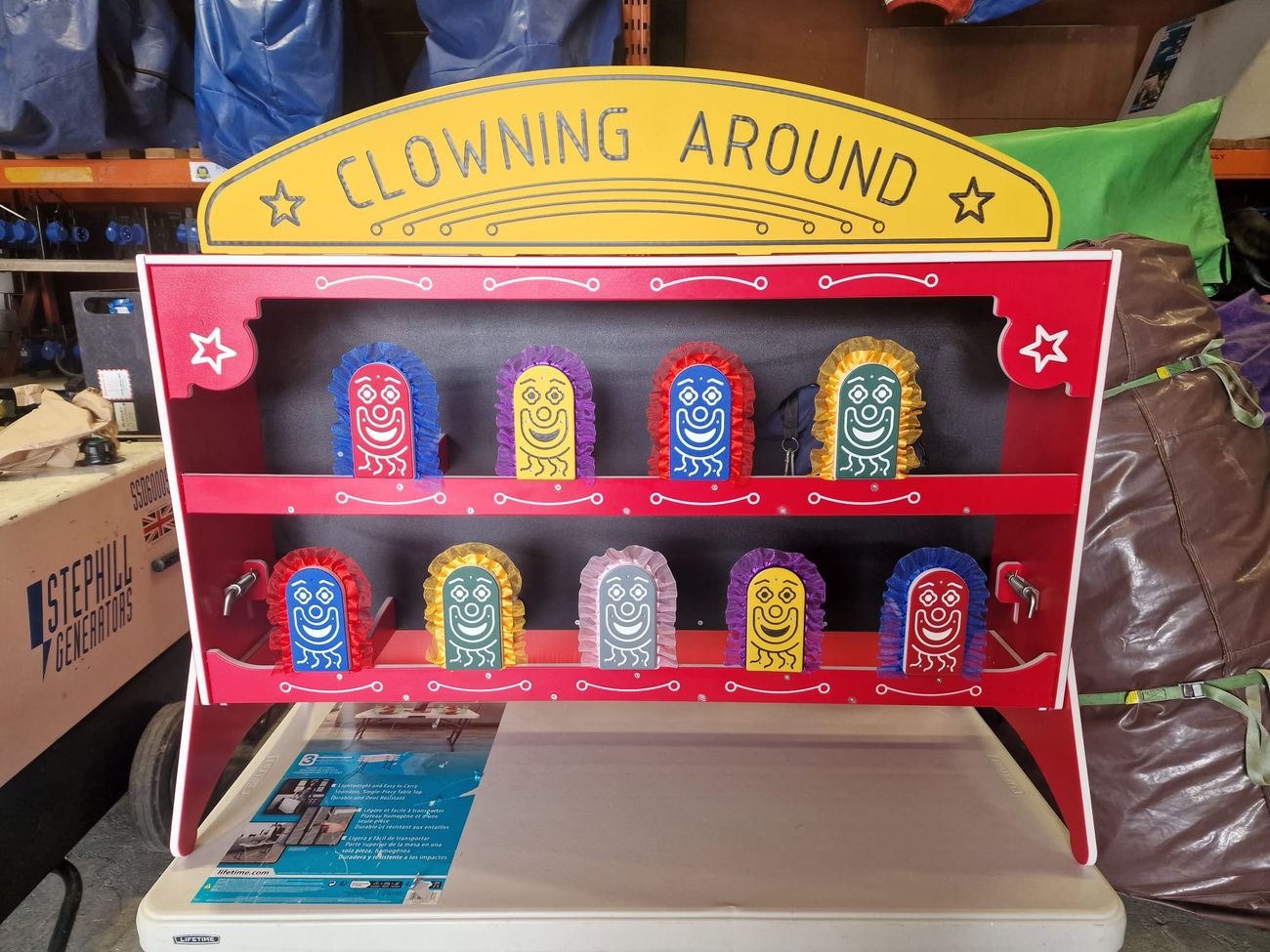 Straight-on view of nine knock-down clown targets arranged in two rows