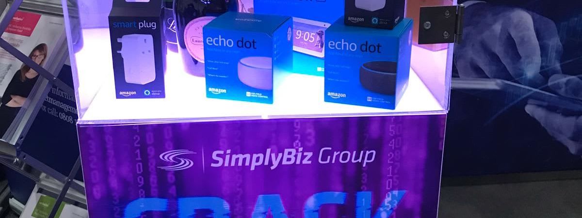 Crack the Code safe on a SimplyBiz Group exhibition stand, stocked with champagne, whisky and Amazon Echo prizes