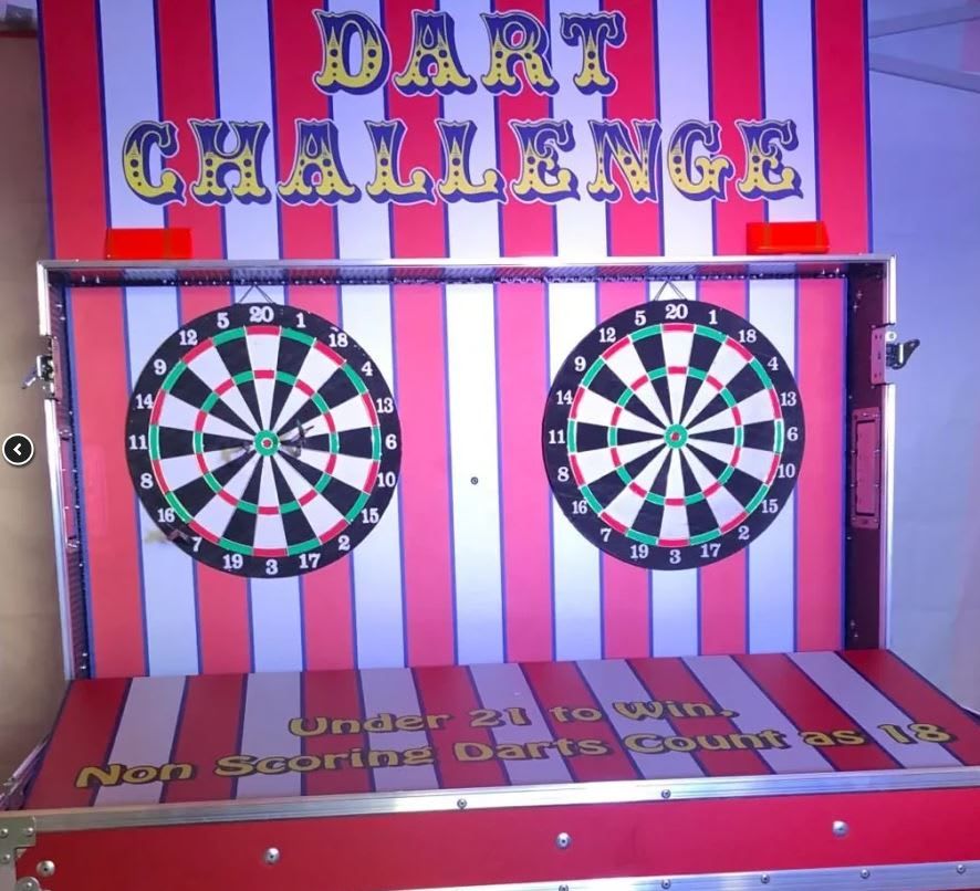 Striped fairground "Dart Challenge" booth with two dartboards and red-and-yellow signage