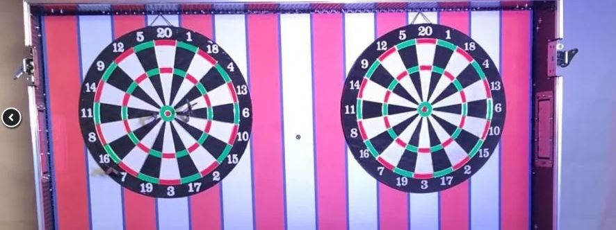 Striped fairground "Dart Challenge" booth with two dartboards and red-and-yellow signage