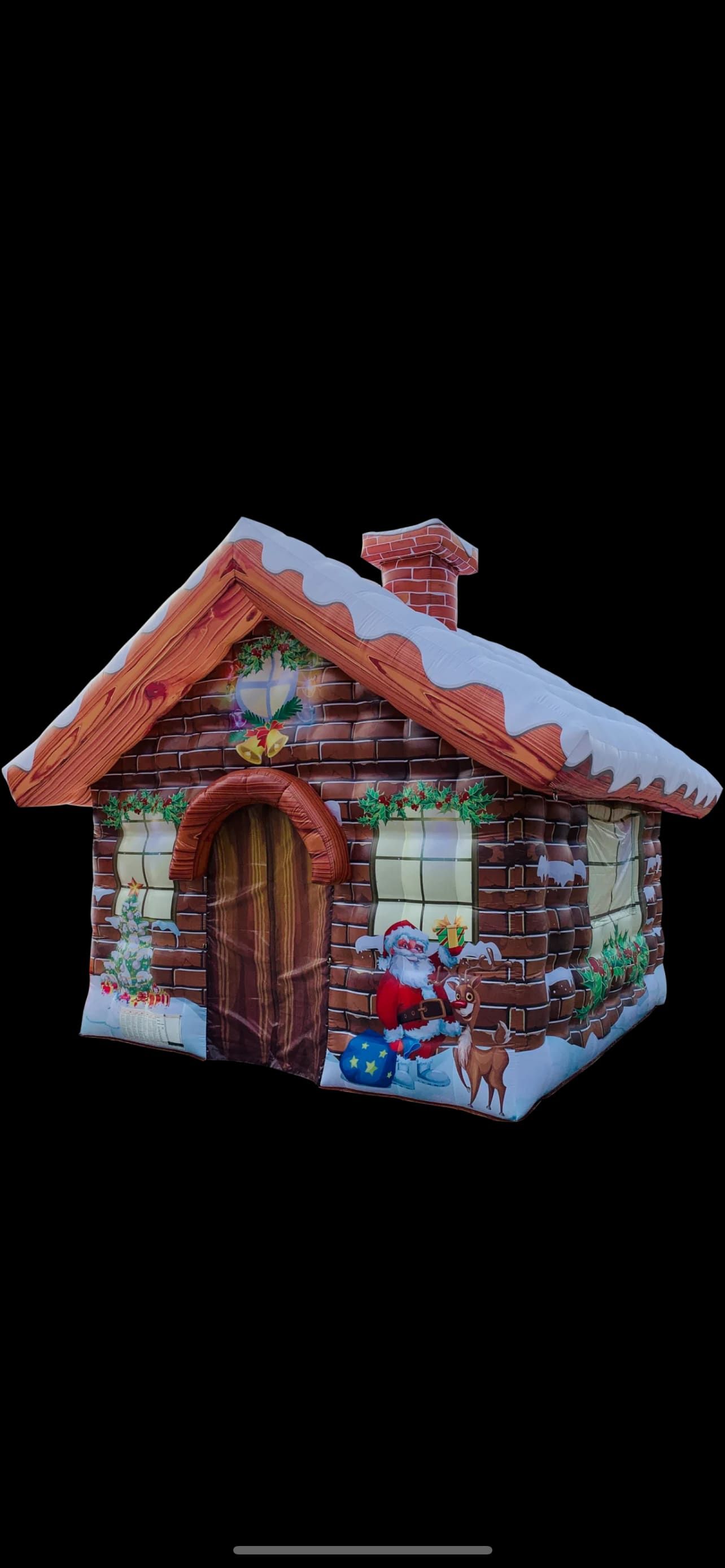 Side view of the inflatable grotto cottage at night showing chimney and snow detailing
