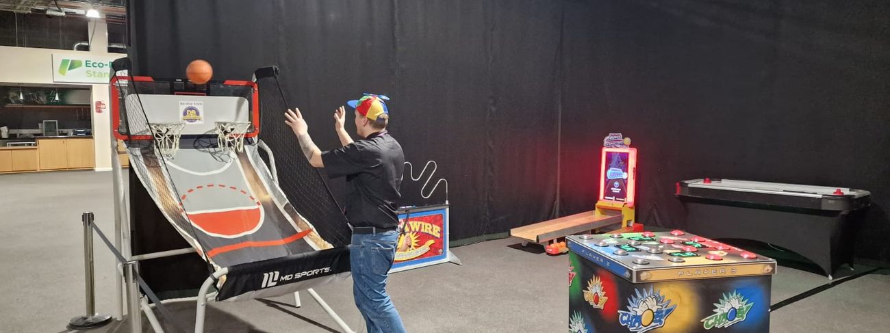 Player taking a shot on the Double Shot basketball game at an indoor exhibition