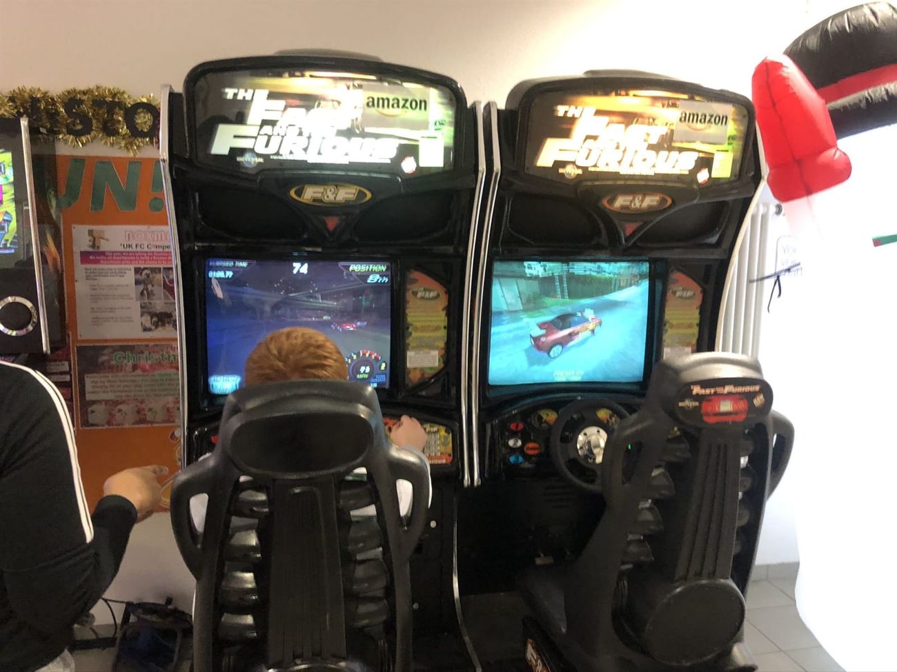 Two players racing head-to-head on the linked Fast and Furious sit-down cabinets