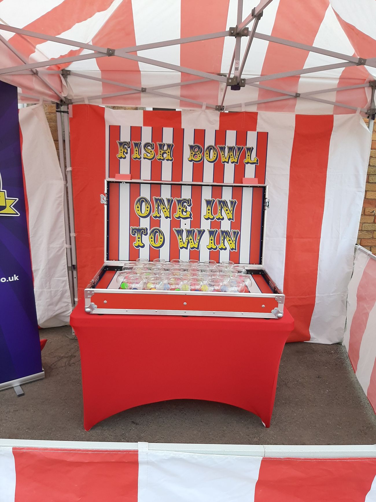 Fish Bowl Challenge game case open under its striped FISH BOWL backdrop, with rows of glass bowls