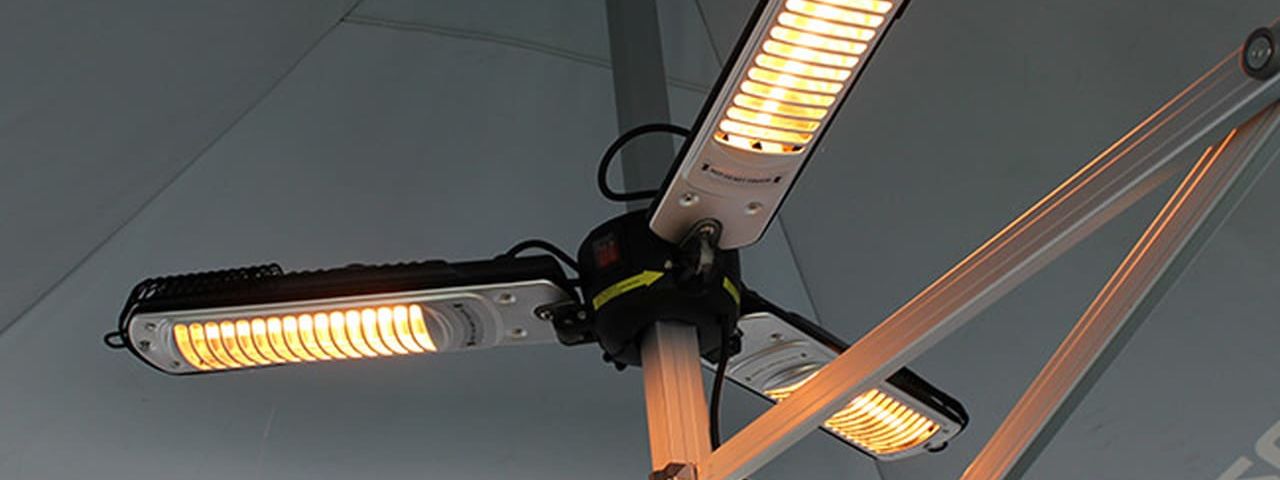 Three-arm infrared gazebo heater glowing under a gazebo canopy
