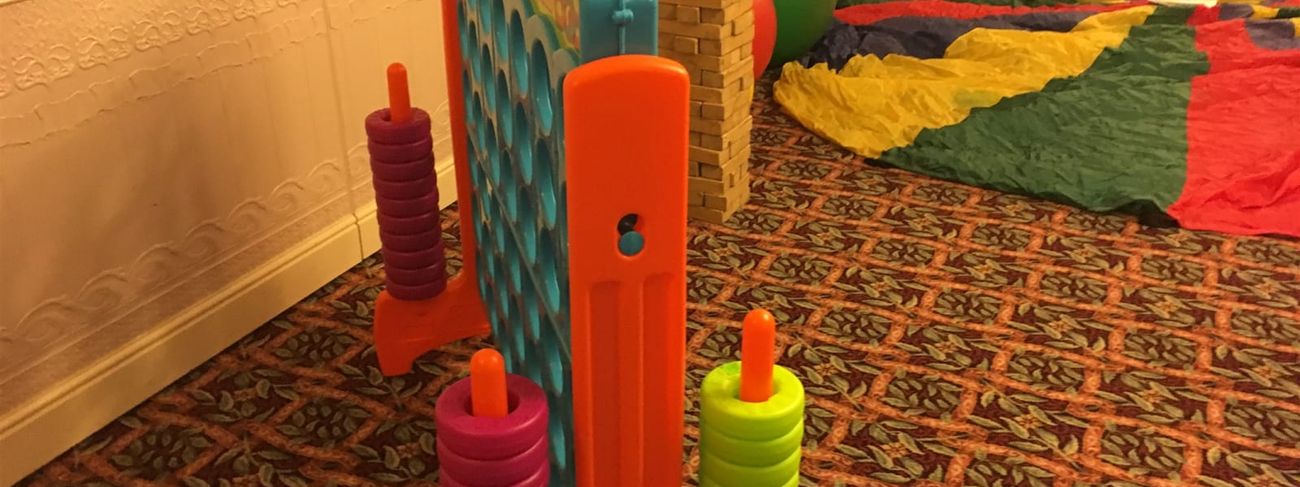 Giant Connect 4 beside Giant Jenga in a relaxed party games area