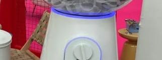White giant gashapon capsule vending machine with a clear dome full of prize capsules, LED lighting ring at the base