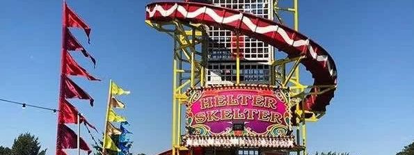 Traditional square-tower helter skelter, 22ft tall with a red-and-white striped slide spiralling down a yellow-framed tower
