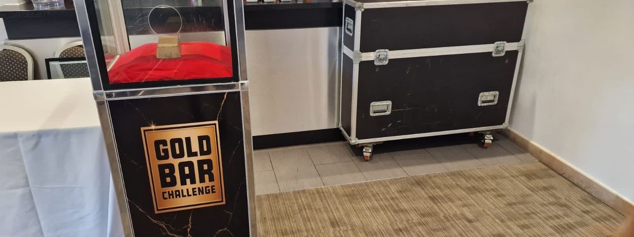Gold Bar Challenge unit with transport flight case set up in a function room