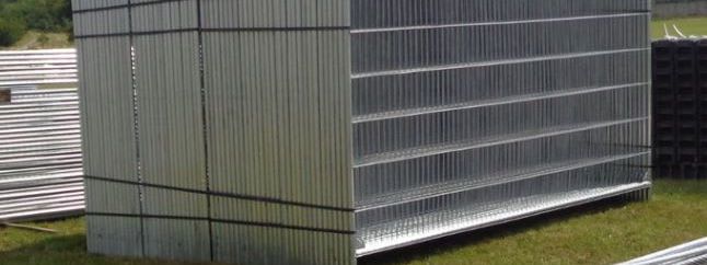 Stacked galvanised mesh panels stored outdoors