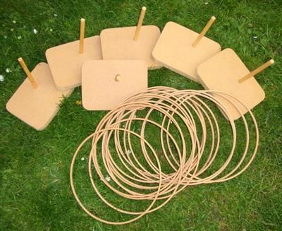 Player tossing a wooden ring over a block to win the prize at a fairground stall